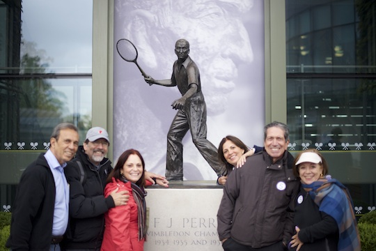 a London Magical Tours group admiring the Fred Perry Statue during a visit to the Wimbledon Lawn Tennis Grounds