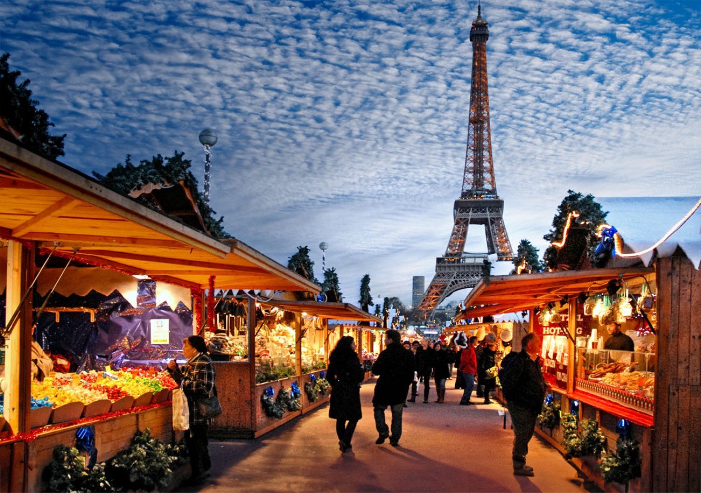 Festive Parisian Christmas market stalls set against the iconic Eiffel Tower.