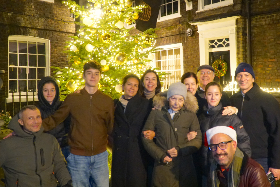 Our cheerful guests pose with the festive partridge in a pear tree behind them.
