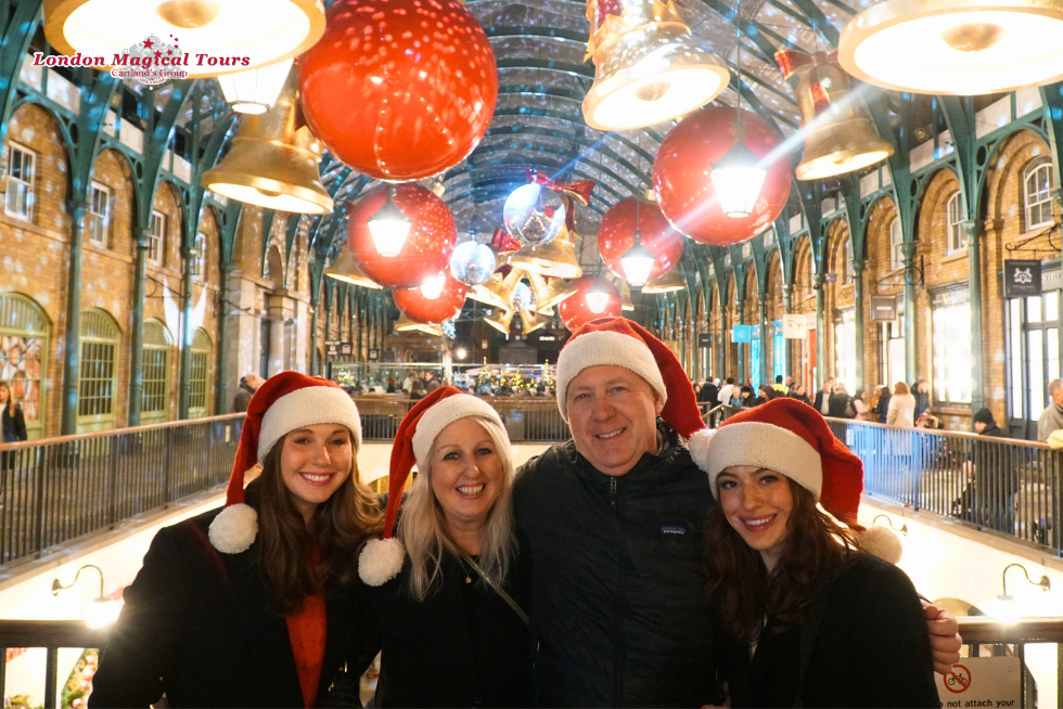 The family capturing a festive moment with the oversized Christmas baubles behind them.
