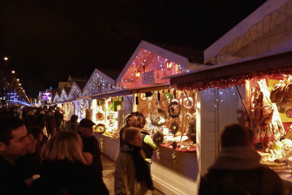 A festive Christmas market in Paris with seasonal stalls and decorations.