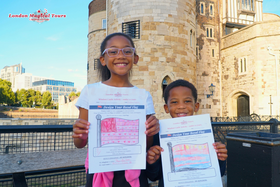 Children proudly show their entries for this year's Create Your Own Royal Flag competition.
