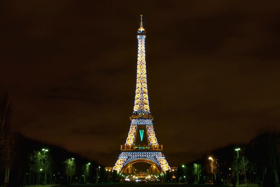 The Eiffel Tower illuminated against the evening sky in Paris.